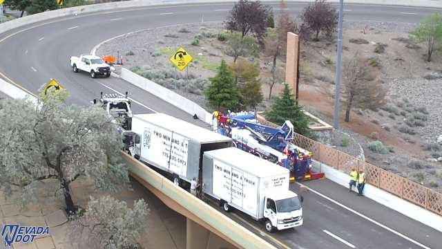 Two workers in high-visibility vests on the right shoulder
