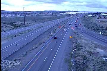 Construction barrels and signs on the right shoulder and lane area of the highway