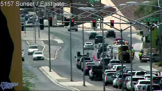 Fire truck and ambulance with a person standing nearby in the right lane