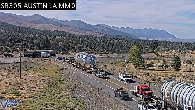 Oversized load with escort vehicles and a boom truck