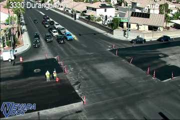 Construction cones and two workers in the right lane