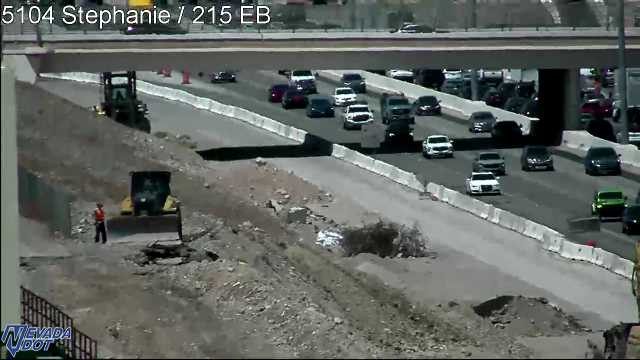 Construction worker and bulldozer on the left embankment