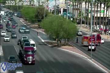 Fire truck and police car on the right shoulder with emergency personnel