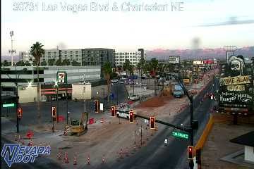Construction zone with an excavator and orange cones blocking lanes in the intersection
