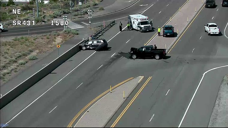 Two vehicles collided in the roadway, with an ambulance and responders present