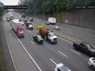 Emergency vehicle with flashing lights on the highway shoulder.