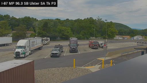 Fire truck and other vehicles present at a rest stop or parking area.