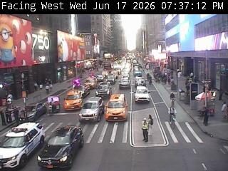Police officer directing traffic at an intersection with heavy traffic.