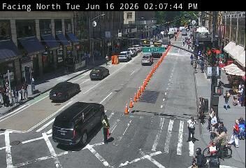 Traffic cones and personnel indicate a possible incident or road work ahead.