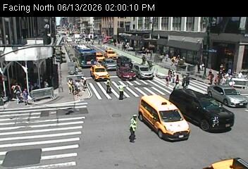 Traffic officers directing traffic at an intersection with multiple vehicles.