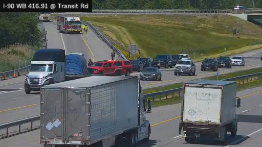 Emergency responders on scene of a traffic incident with multiple vehicles involved.