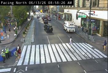 Ambulance and personnel on scene at a crosswalk.