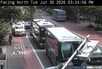 Police car and tow truck with lights on in the left lane
