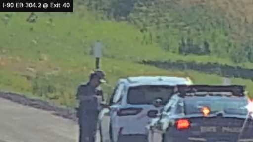 State trooper interacting with a driver on the right shoulder