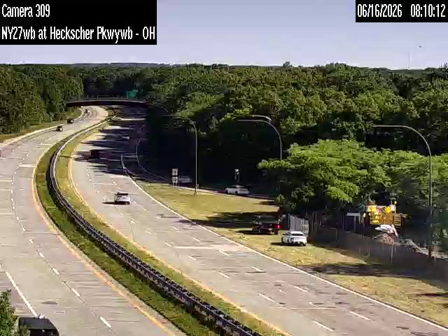 Construction equipment and materials are present on the roadside, possibly indicating work or an incident.