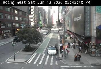 Police car and officers present at a busy intersection.