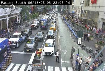 Police and emergency vehicles on scene with personnel and cones in traffic.