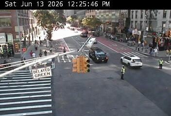 Traffic light pole down, responders present on roadway.