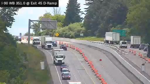 Emergency responders on scene with traffic cones and vehicles on the right shoulder.