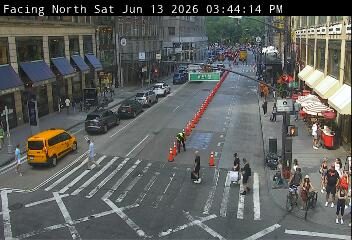 Traffic cones and personnel indicate a possible incident or road work ahead.