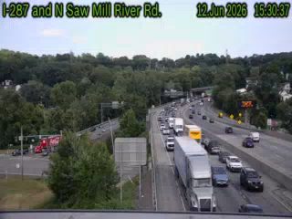 Emergency responders and vehicles are present on the side of the highway, indicating an incident.