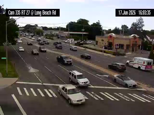 Ambulance on scene at intersection with traffic.