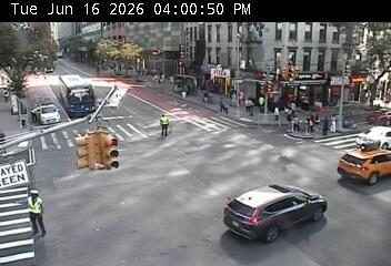 Two traffic responders directing traffic at an intersection with a broken traffic light.