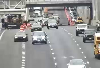 Emergency responders and equipment are present on the roadway, directing traffic.