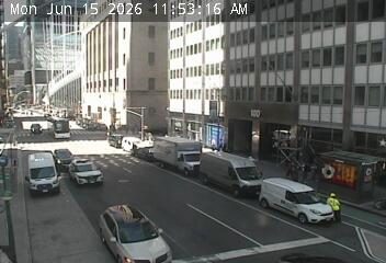 Responder in yellow vest directing traffic near a white van.