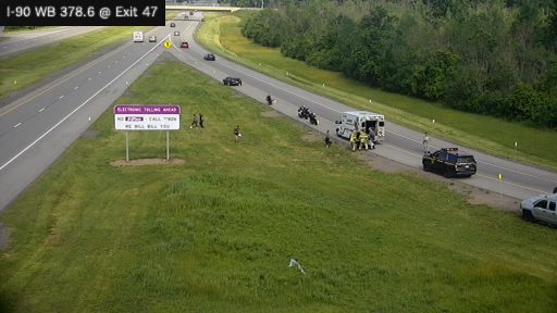 Ambulance and police vehicle with personnel on the right shoulder