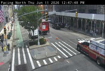 Fire department vehicle on scene with personnel and cones on-road activity.