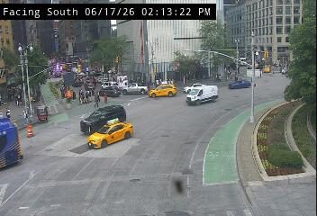 Emergency vehicles and personnel are present at an intersection, indicating an incident.