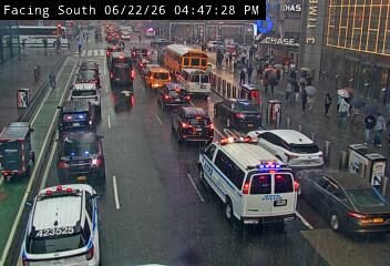 Police van with lights on in the right lane