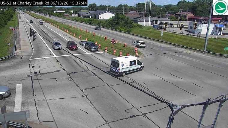 An ambulance is present on the roadway, indicating a potential incident.