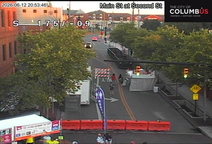 Road closed with barriers and tents, possibly for an event or construction.