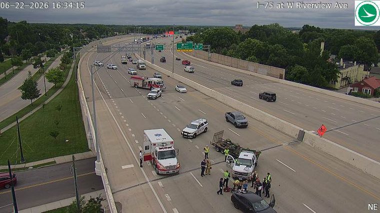 Multiple emergency vehicles and personnel in the roadway