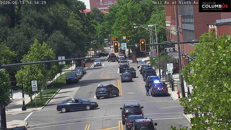 Police officers and vehicles are present on the roadway, indicating an incident.