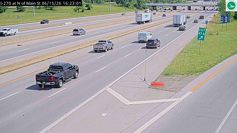 Black pickup truck leaking fluid onto the roadway.