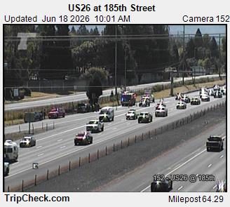 Emergency vehicles, including a fire truck, are present on the roadway.