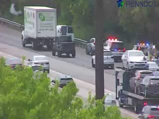 Police car with red and blue lights on the right shoulder