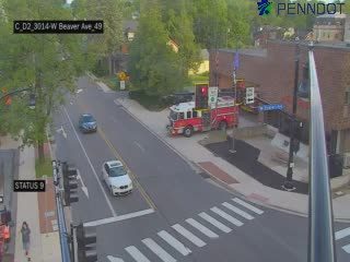 Fire truck and emergency personnel on scene at intersection.
