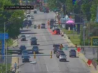 Emergency responders and construction workers are present on the roadway.
