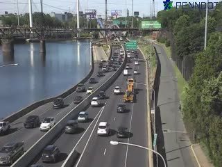 Yellow construction vehicle on the right shoulder of the highway.