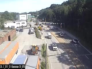 Emergency vehicles and construction equipment are present on the roadway.