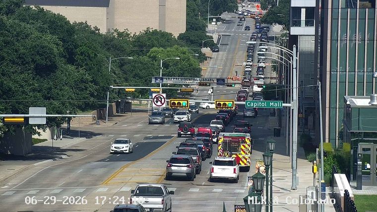Fire truck with flashing lights in the right lane