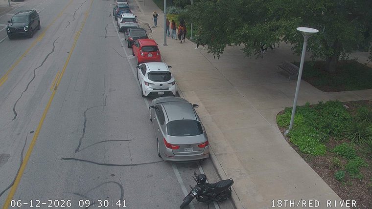 Motorcycle lying on its side on the roadway shoulder.