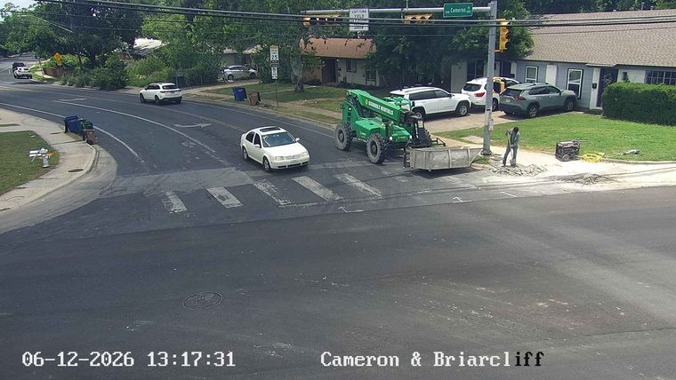 Construction crew working on road with equipment and debris.