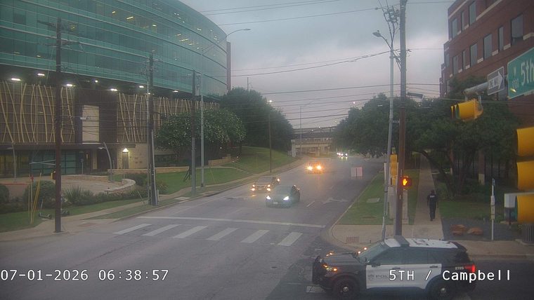 Police car with lights on in the right lane