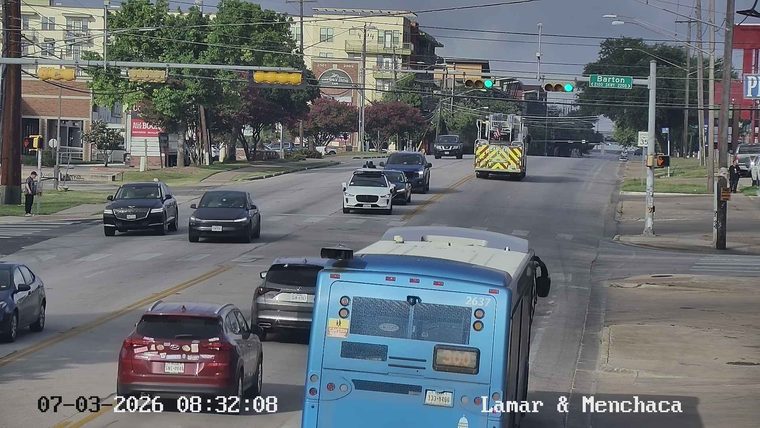 Fire truck with flashing lights in the right lane
