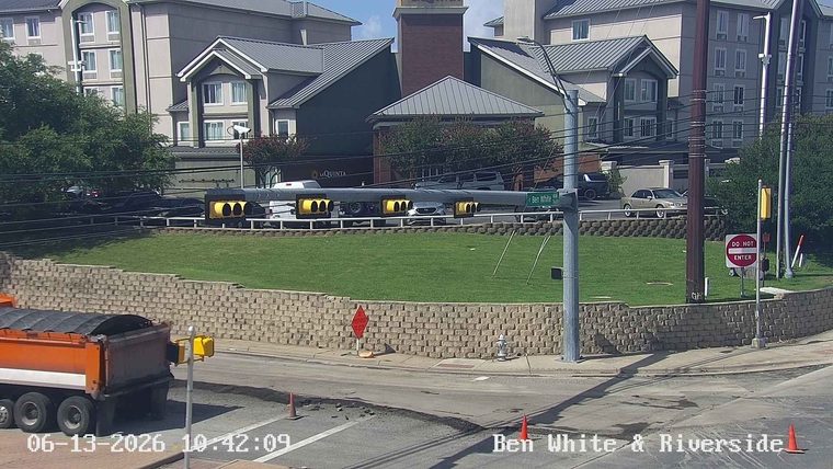 Road work in progress with debris and cones on the roadway.